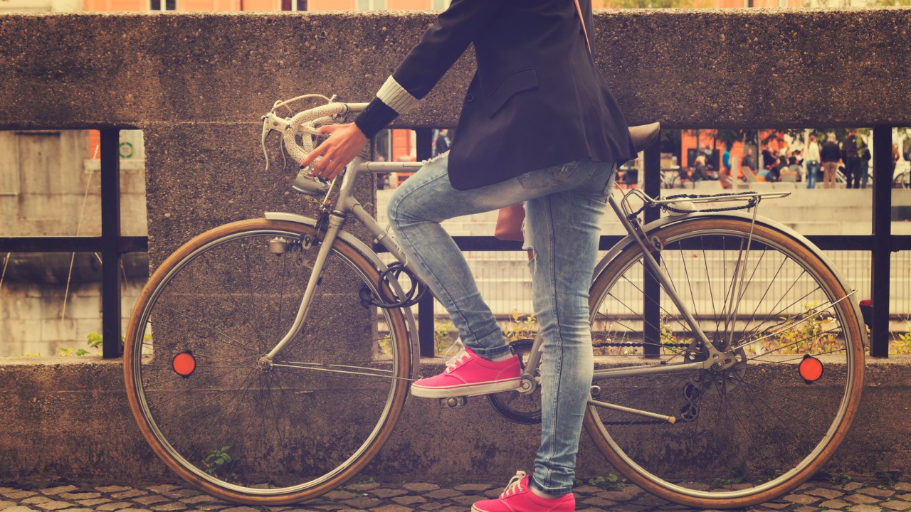 Mulher subindo na bicicleta